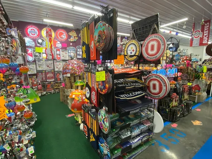 a vibrant store interior filled with colorful novelty signs, decor, and gifts. bold signs feature university logos and themes, creating a lively atmosphere.