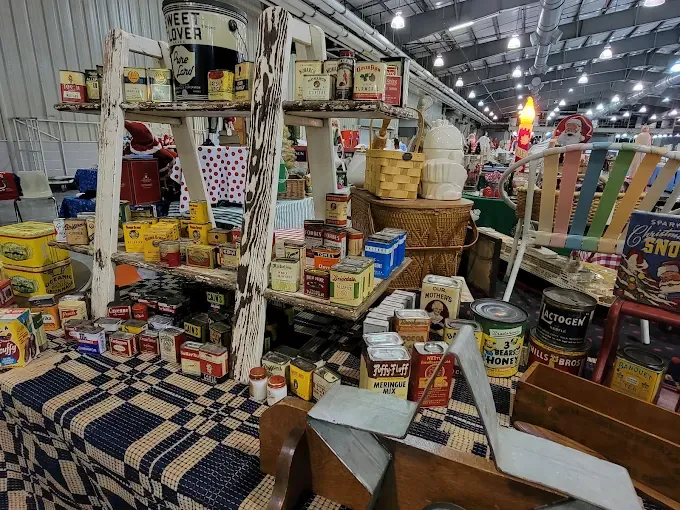 tulsa flea market booth with rustic shelves displaying assorted cans, tins, and baskets.