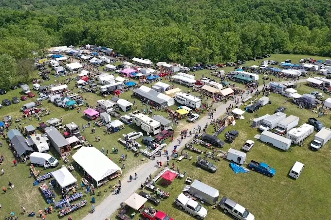 aerial view of a bustling outdoor market with numerous white tents and vendor stalls. muskingum valley (reinersville) trade days