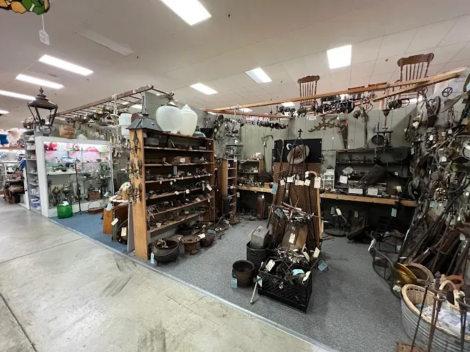 antique shop interior filled with various vintage items like lamps, glassware, and tools at springfield antique center