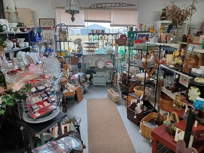 organized aisle at hfm emporium showcasing a variety of kitchenware, glassware, and woven baskets.