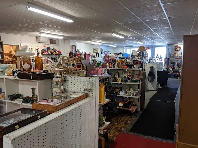 The circle antique & flea market a well-lit interior filled with various items on shelves, including ceramics, toys, and decor. the atmosphere feels cozy and nostalgic.